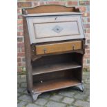 AN EARLY 20TH CENTURY OAK STUDENT’S BUREAU The shaped gallery above a fall front, single drawer,