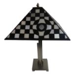 AN ART DECO STYLE TABLE LAMP With leaded glass shade of checker board design, on a brushed aluminium