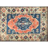 A HAMADAN WOOLEN RUG With hooked central lozenge and floral medallions within frieze and running