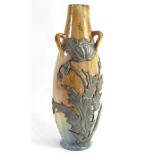 AN ART NOUVEAU FRENCH POTTERY AND PEWTER VASE Having three handles and applied pewter flowers and