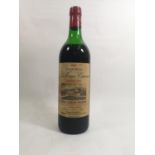 A BOTTLE OF 1969 CHÂTEAU LA TOUR CANON FRONSAC RED WINE Having a red metal cap and cream tone