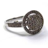 A 9CT WHITE GOLD AND DIAMOND RING Pavé set circular crown with diamond shoulders (size P).