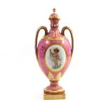 MINTON, A BONE CHINA TWIN HANDLED VASE AND COVER OF SÈVRES STYLE Decorated with a girl with