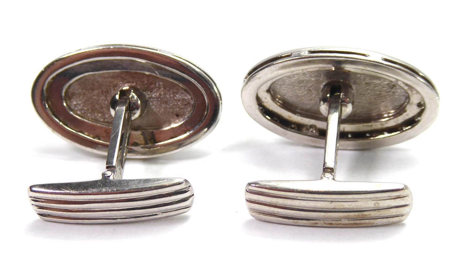 A PAIR OF OVAL FORM WHITE METAL AND DIAMOND CUFFLINKS. (16.9g - Image 3 of 5