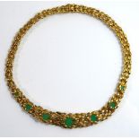 A VINTAGE YELLOW METAL AND CHRYSOPRASE NECKLACE Set with graduated chrysoprase discs and textured