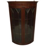 A REGENCY STYLE MAHOGANY BOW FRONTED CORNER CABINETwith two glazed doors66 x 47 x 105 cm