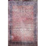 AN EARLY 20TH CENTURY HAND WOVEN PERSIAN RUG OF CARPET PROPORTIONS The central floral field