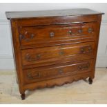 AN EARLY 19TH CENTURY FRENCH PROVINCIAL OAK CHEST OF DRAWERS The moulded rounded rectangular top