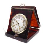 AN EARLY 20TH CENTURY BERTHOUD GENEVE TORTOISE SHELL TRAVELLING ALARM CLOCK With a folding case