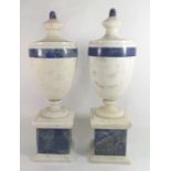 A PAIR OF ITALIAN MARBLE URNS Classical form with lapis lazuli finals and banding, raised on