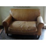 A FAUX CROCODILE TAN LEATHER TWO SEAT SETTEE With loose cushions, on square tapering legs. (138cm
