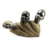 A 20TH CENTURY AFRICAN STONE FIGURAL CARVING Three heads carved at an angle with a textured