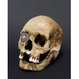 A 19TH CENTURY KORWA TRIBE ANCESTOR HUMAN SKULL.