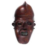 AN AFRICAN CARVED WOOD AND ANTELOPE SKIN TRIBAL FACE MASK From the Widekum Cross River, Region of