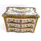 A LATE 19TH/EARLY 20TH CENTURY FAIENCE POTTERY CASKET Modelled as a miniature chest of drawers, hand