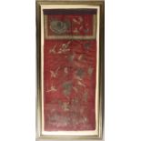 AN EARLY 20TH CENTURY CHINESE SILK EMBROIDERYwith birds amongst flowers on a red ground framed and
