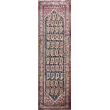 A MIDDLE EASTERN DESIGN RUNNER The madder field with Boteh motifs throughout, contained within three