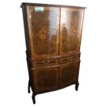 AN ITALIAN WALNUT AND FLORAL INLAID DRINK’S CABINET With two four doors and central drawers. (86cm x