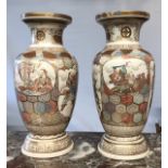 A PAIR OF EARLY 20TH CENTURY JAPANESE SATSUMA VASES Decorated with immortals. (40cm)