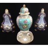 A PAIR OF CONTINENTAL PORCELAIN LIDDED VASESThree-sided tapering form with reticulated design