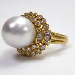 A 14CT GOLD COCKTAIL RING SET WITH A LARGE PEARL Surrounded by baguette and brilliant cut diamonds.