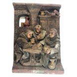 A 20TH CENTURY DUTCH TERRACOTTA RELIEF MOULDED FIGURAL GROUP Tavern scene, monks, bearing a plaque