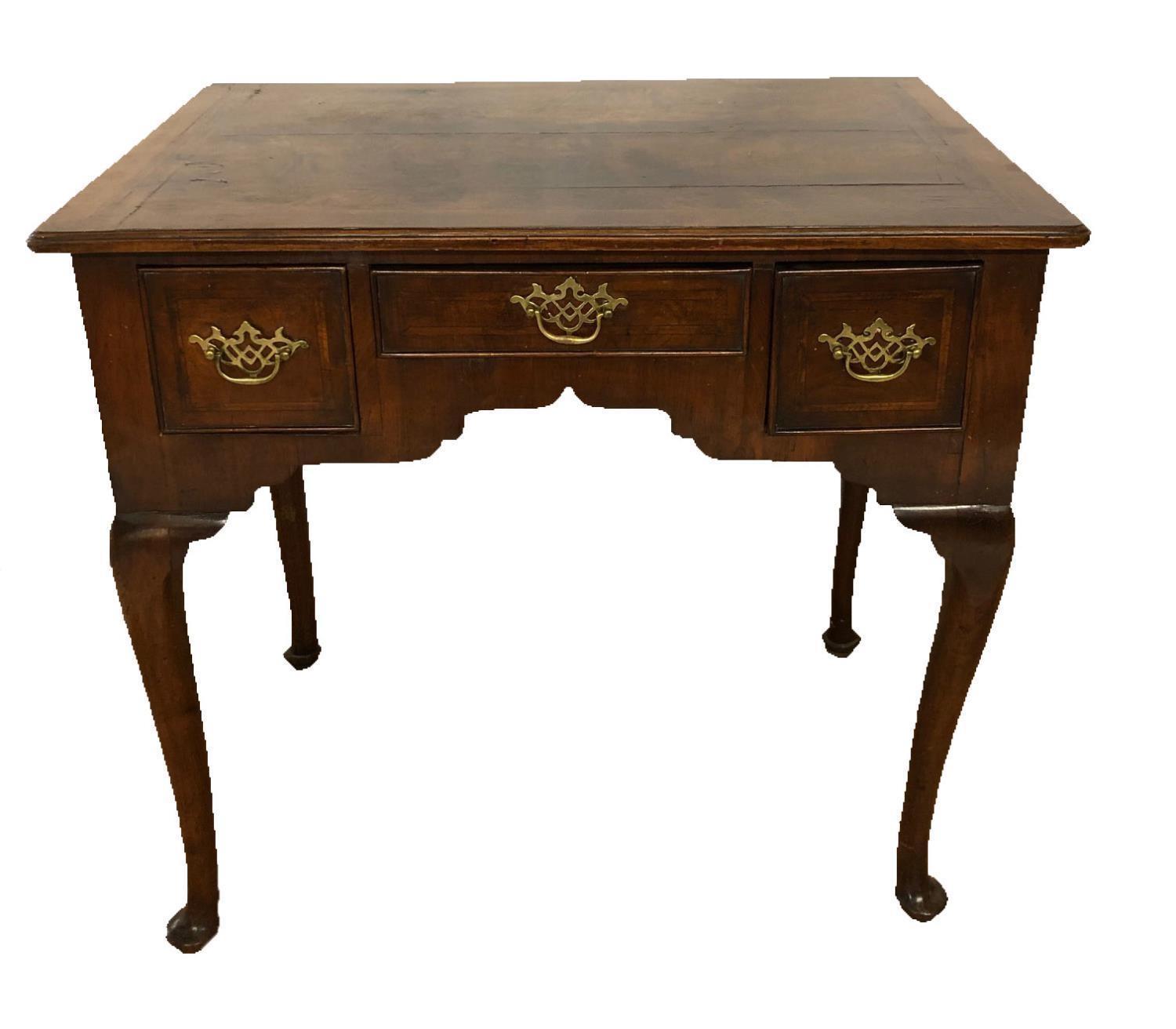 AN 18TH CENTURY WALNUT LOW BOYthe three drawers fitted with pierced brass handles on cabriole legs