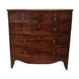 AN EARLY 19TH CENTURY MAHOGANY BOW FRONTED CHEST Of two short above three long drawers, fitted