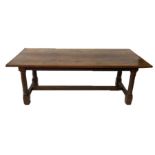 A 19TH CENTURY ELM AND OAK REFECTORY TABLE With three plank top, raised on cannon barrel legs,