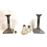 A PAIR OF EARLY 20TH CENTURY SILVER PLATED CLASSICAL COLUMN CANDLESTICKS On stepped square bases,