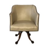 AN EARLY 20TH CENTURY SWIVEL OFFICE CHAIR In cream faux leather upholstery, on mahogany base with