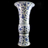 AN 17TH/18TH CENTURY CHINESE BLUE AND WHITE FLARED NECK VASE With a tapering and bulbous body,