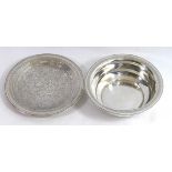 A CONTINENTAL SILVER DISH Finely engraved with Islamic scrolls, together with a shallow bowl with