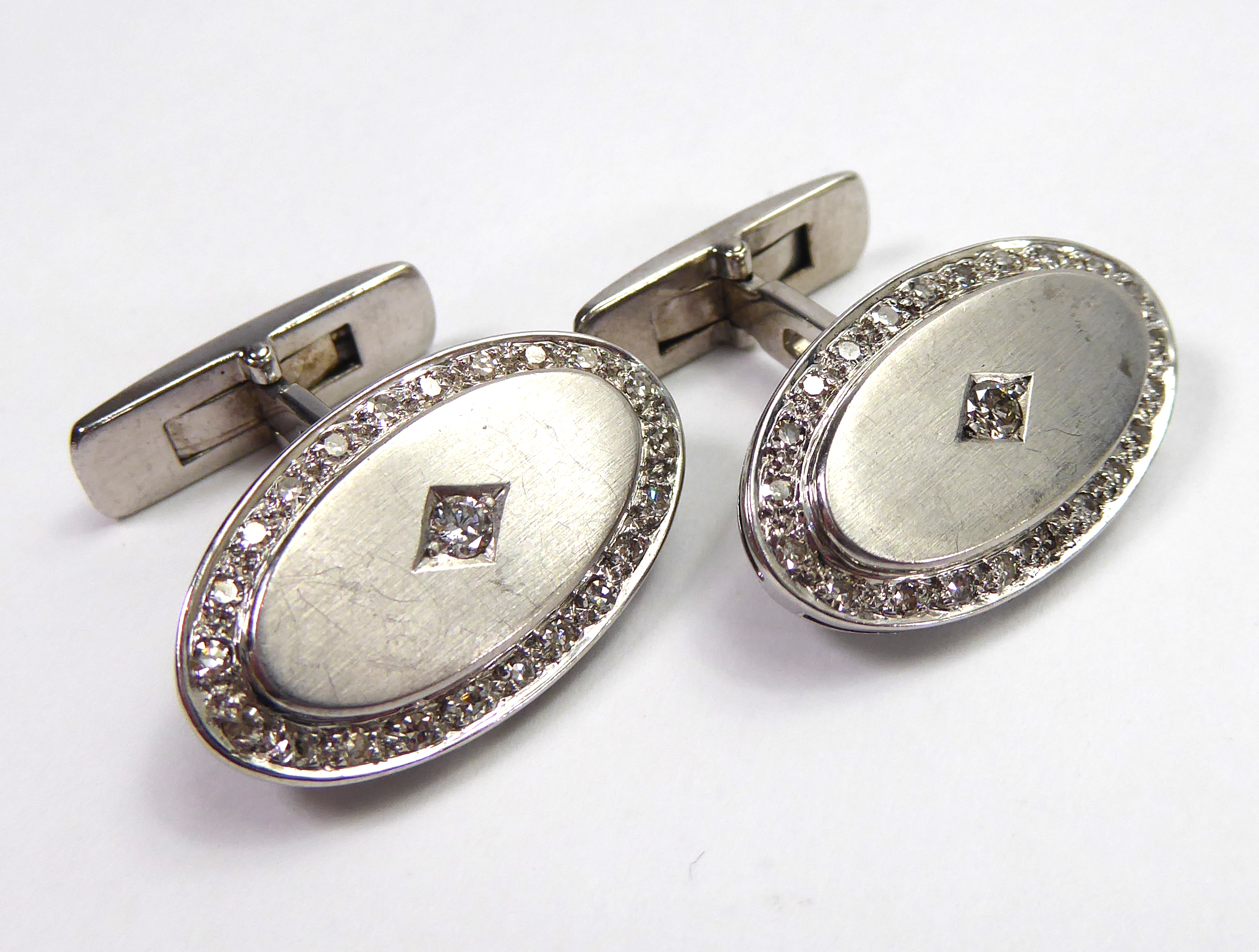 A PAIR OF OVAL FORM WHITE METAL AND DIAMOND CUFFLINKS. (16.9g - Image 4 of 5