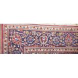 A PERSIAN DESIGN WOOLLEN RUGThe madder field with pendant medallion and floral decoration within