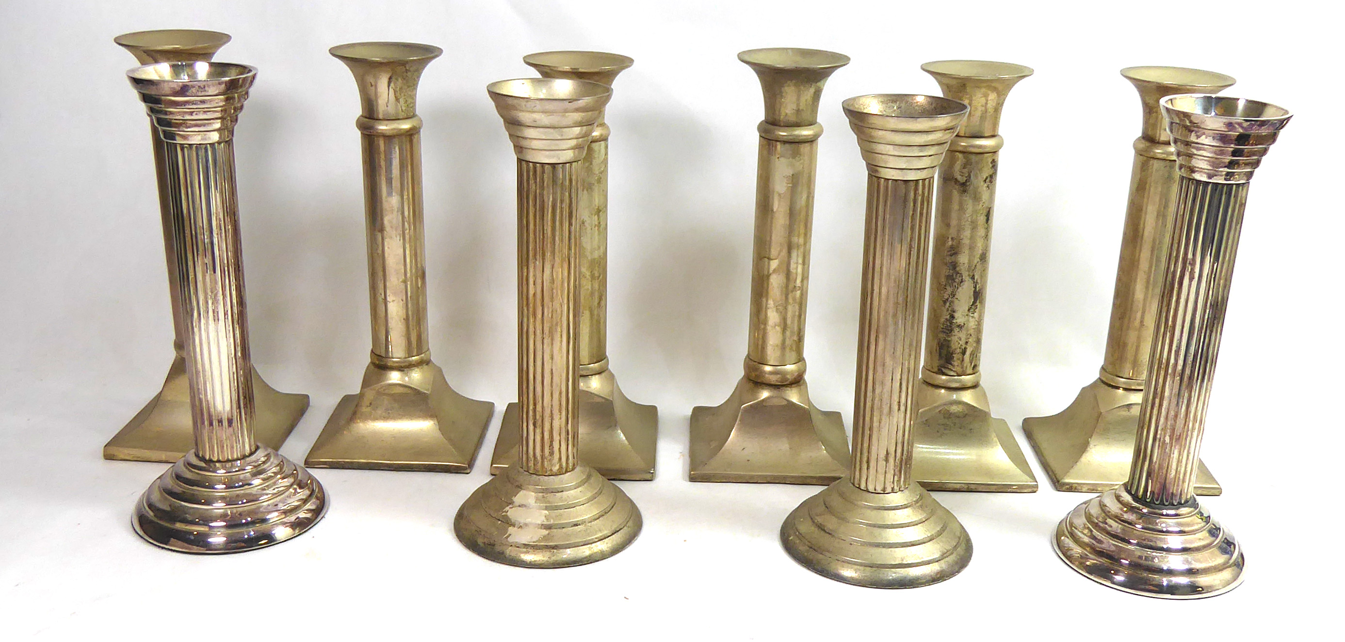 PARKS, LONDON, A SET OF SIX WHITE METAL CANDLESTICKS With cannon barrel columns, along with