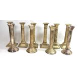 PARKS, LONDON, A SET OF SIX WHITE METAL CANDLESTICKS With cannon barrel columns, along with