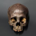 A 19TH CENTURY DAYAK TRIBE HEADHUNTERS CARVED TROPHY HUMAN SKULL.