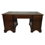 A 19TH CENTURY MAHOGANY PEDESTAL DESKWith green tooled leather top over six drawers fitted with