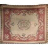 A LARGE AUBUSSON CARPET Floral designs on an ivory field with a salmon pink border. (240cm x 300cm)