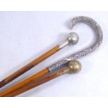 AN EARLY 20TH CENTURY WHITE METAL AND MALACCA WALKING STICK Having a crook form handle with scrolled