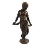 A 20TH CENTURY BRONZE FIGURE OF A LADY Wearing long flowing robes and raised on a circular base. (