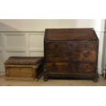 A 19TH CENTURY STAINED PINE FALL FRONT BUREAU Having an arrangement over three drawers and turned