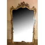 A 19TH CENTURY GILT FRAMED MIRROR Coasted with a cartouche above a shaped bevelled plate and oak