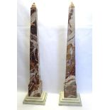 A LARGE PAIR OF ITALIAN VARIEGATED ROUGE MARBLE OBELISKS On a stepped grey marble base. (approx