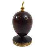 THEO FABERGÉ, A 20TH CENTURY ?PURPLE HEART? FABERGÉ EGG With shaped finial over ring inlay, raised