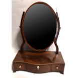 A GEORGIAN MAHOGANY TOILET MIRROR With ivory finial and handles, the oval silvered plate above three