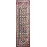 A MIDDLE EASTERN DESIGN RUNNER The madder field with Boteh motifs throughout, contained within three