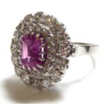 AN 18CT WHITE GOLD, PINK SAPPHIRE AND DIAMOND RING Having a central emerald cut sapphire , edged