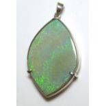 A LARGE OPAL AND SILVER PENDANT The single oval cut stone set in a heavy gauge silver mount. (approx